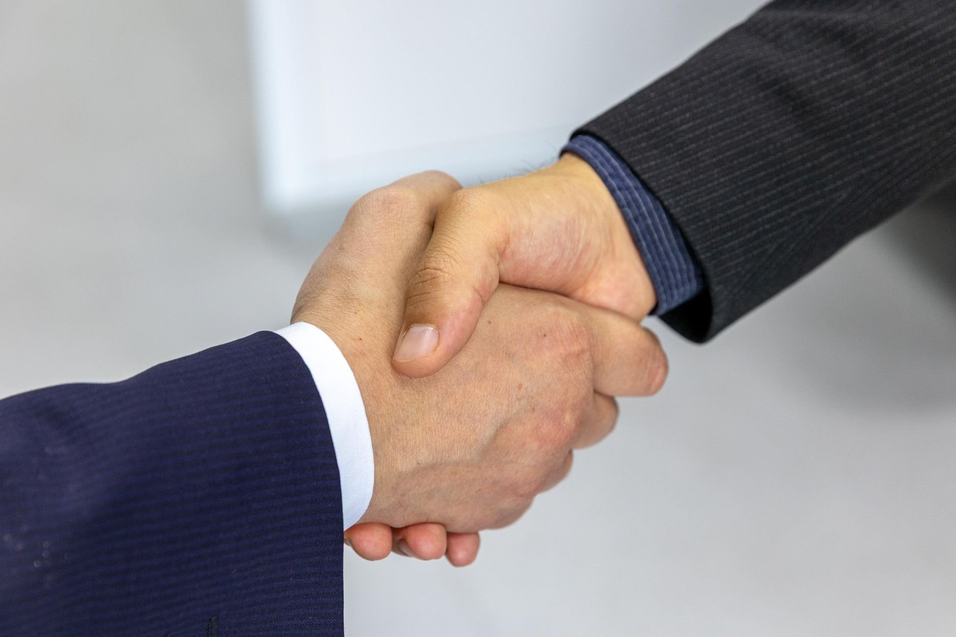 Two people shaking hands, symbolizing a successful agreement